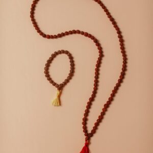 Beautiful arrangement of rudraksha beads on a beige background, showcasing traditional craftsmanship.